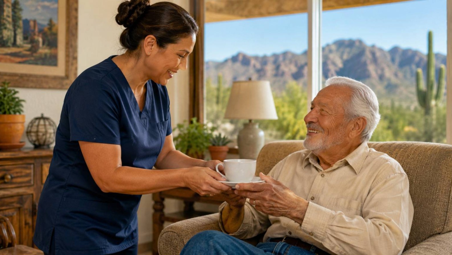 A professional caregiver serving tea to a smiling senior man at home in Tucson during respite care