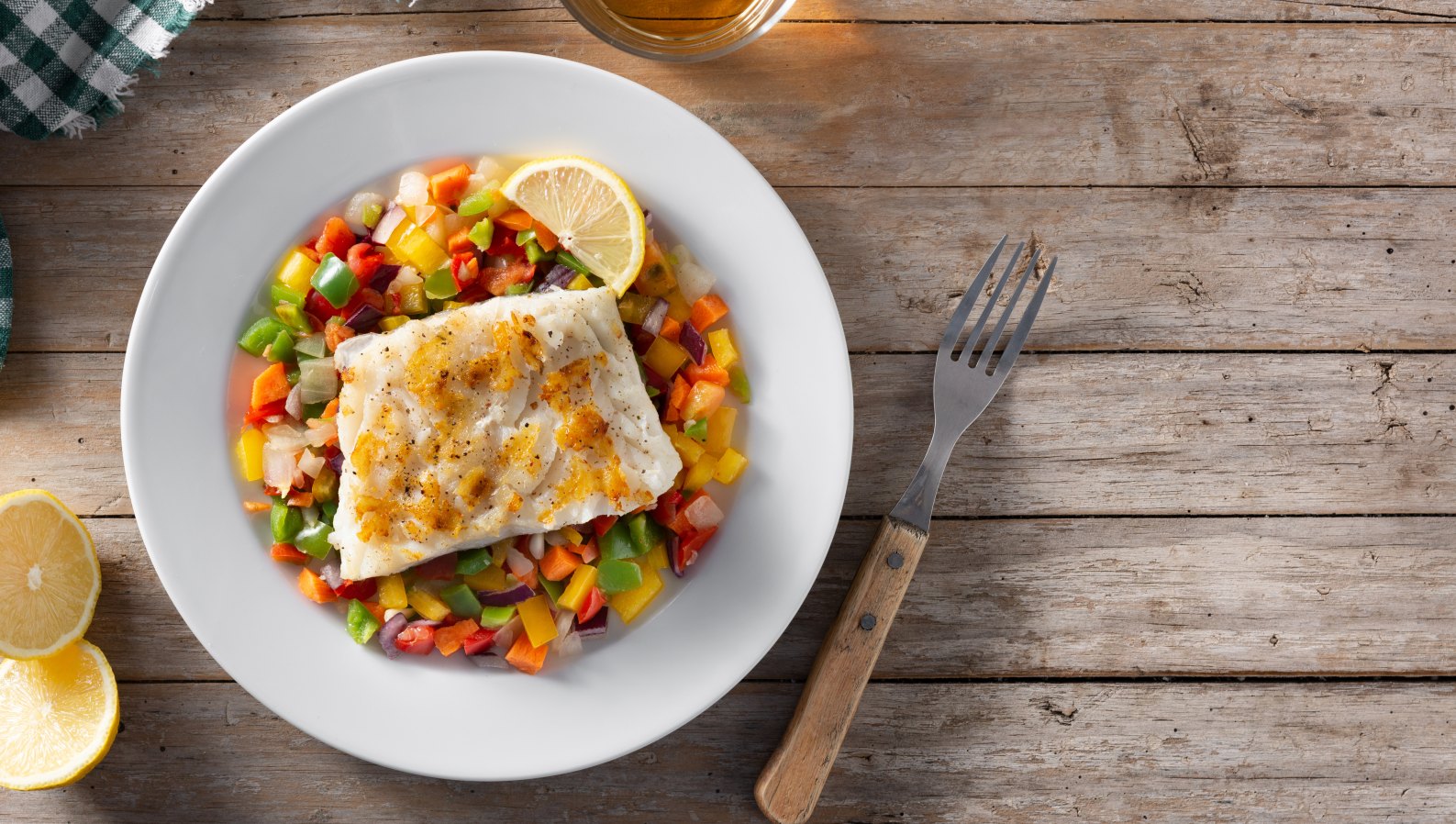 A healthy, colorful plated meal with vegetables on a wooden table