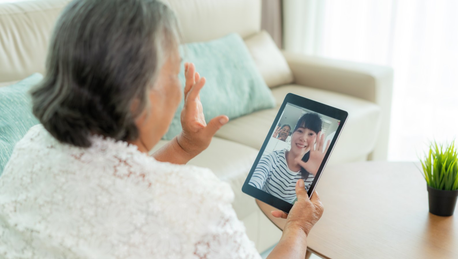 A senior woman on a video call with family, staying connected