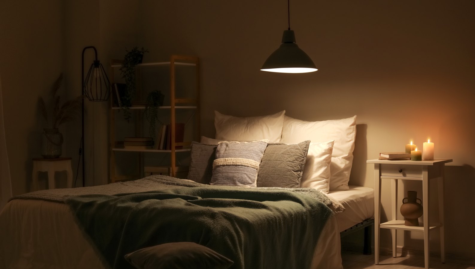 A cozy bedroom softly lit by a lamp at night