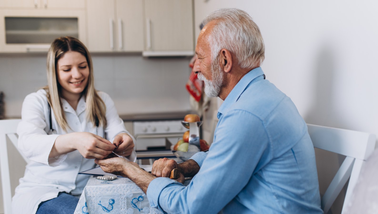 A caregiver attentively caring for a senior at home